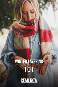 Blonde woman wearing a red, olive and orange scarf in a denim dress with a tree behind her. Text includes, 