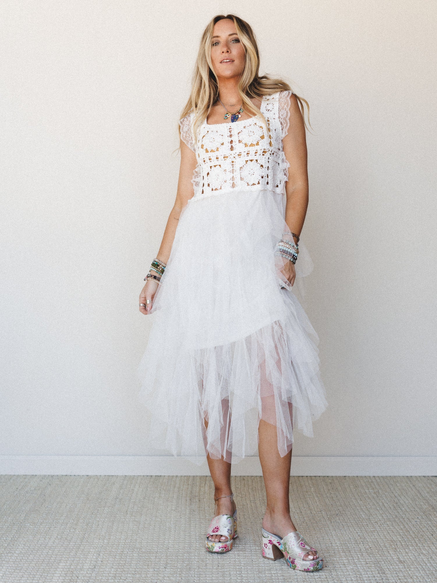 white disco dress PAXTON HALTER NECK PU MIDI IN boo detailing Flowing tulle skirt with asymmetrical hem offers dreamy movement and romantic texture Sleeveless design with scalloped straps provides comfortable wear for dancing under the stars Midi length silhouette transitions seamlessly from boho chic daywear to festival outfit perfection Lightweight construction makes this boho dress ideal for layering with kimonos or cardigans Your new go Desert Disco Dress - White