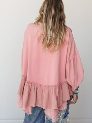 Shot from the back, this dusty rose top layers mixed textures beautifully — a flowy body gives way to a ruffled gauze hem with eyelet trim, styled with worn-in jeans and stacked bracelets for that effortlessly collected feel.