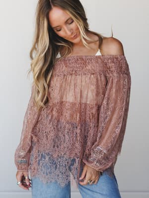A dreamy dusty mauve lace off-shoulder tunic paired with light-wash denim — the kind of top that makes a Tuesday feel like something worth remembering.