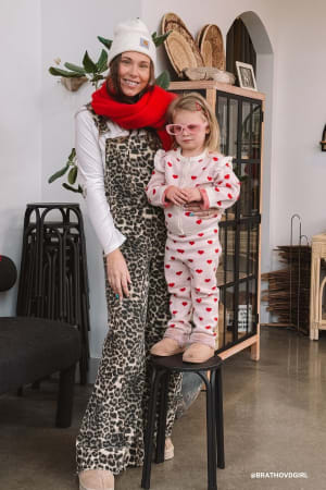 Woman and child in a cozy indoor setting with decorative items.