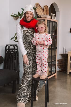Woman and child in a cozy indoor setting with decorative items.
