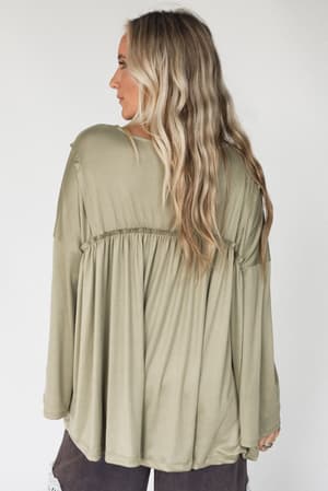 back view of The Nest Solid Serenity Long Sleeve Babydoll Top in Olive from Three Bird Nest