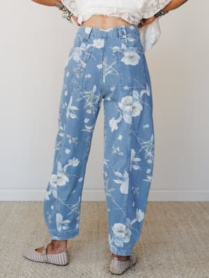 Shot from the back, these medium wash floral denim barrel jeans are styled with a cropped lace top and woven flats — soft, expressive, and very much the kind of jeans you'd wear to prove that denim doesn't have to be serious.