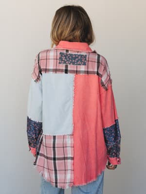 Shot from the back, this patchwork button-down shacket layers plaid flannel, corduroy panels, and floral print fabric in a playful mix of coral, blush, and navy — the kind of piece that looks intentionally thrown-together in the best way.
