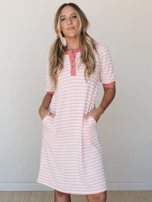 A pink and white striped ribbed henley dress with puff sleeves and side pockets — the kind of dress that blurs the line between cozy and put-together in the best possible way.