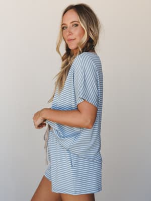 A relaxed matching set in soft denim blue and white stripes — the kind of outfit that blurs the line between 'just woke up' and 'actually going somewhere' in the best possible way.