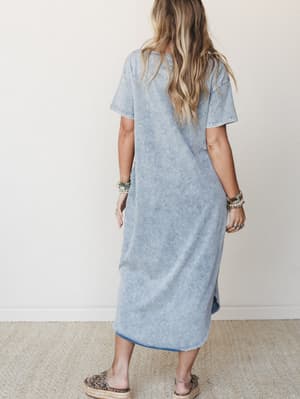 Shot from the back, a model in a relaxed acid-wash maxi tee dress pairs stacked boho bracelets and leopard print flatform sandals — the kind of effortless outfit that looks like you tried just the right amount.