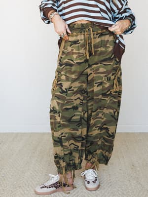 Relaxed camo cargo joggers styled with a bold stripe sweater and leopard print sneakers — the kind of mix-it-all-together outfit that somehow just works.