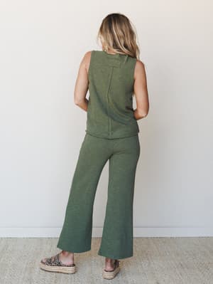 A model shot from behind showcasing a matching olive knit tank and wide-leg pant set, styled with leopard print espadrille flatforms — easy, put-together, and the kind of outfit you reach for on repeat.