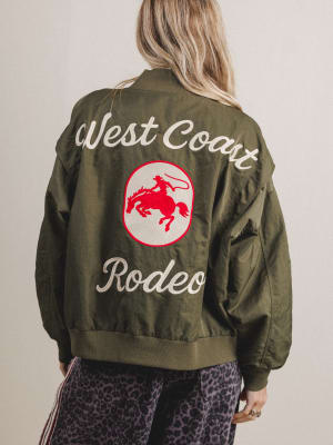 Green jacket with 'West Coast Rodeo' text and logo on a plain background