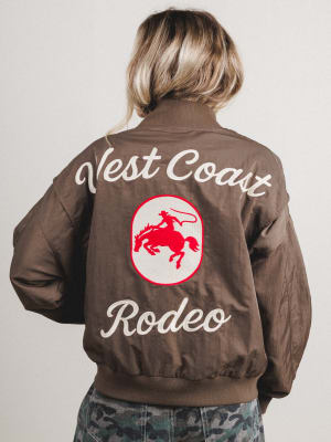 Person wearing a brown jacket with 'West Coast Rodeo' text and logo on the back.