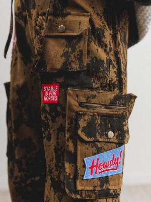 Camouflage jacket with patches on a plain background