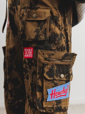 Camouflage jacket with patches on a plain background