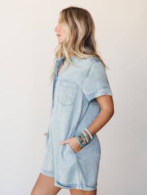A light-wash denim romper styled with a stack of turquoise and mixed-bead bracelets — easy, lived-in, and the kind of outfit you throw on and just go.