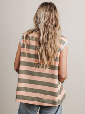 Woman wearing a striped sleeveless top with a neutral background