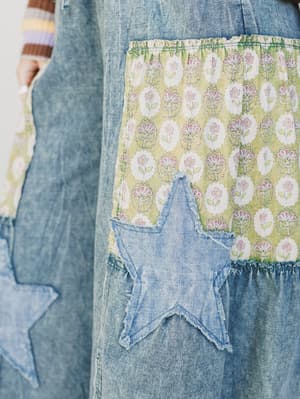 Denim apron with floral pocket and star-shaped patch