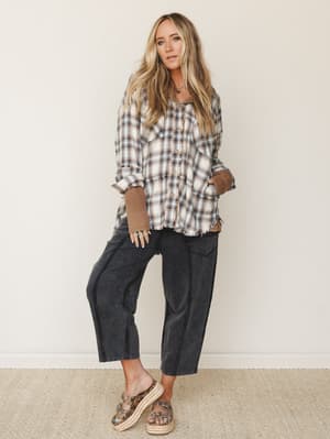 A relaxed, lived-in outfit built around oversized plaid layering and roomy barrel-leg pants — the kind of effortless cool that looks like you just threw it on but definitely didn't.
