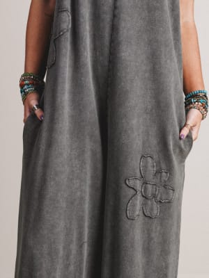 Gray dress with a floral embroidery detail on a plain background