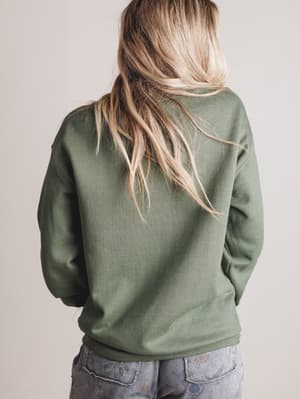 Person wearing a green sweatshirt from behind on a plain background
