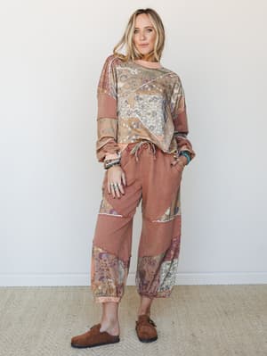 A patchwork matching set in warm earthy tones — the kind of outfit that looks like you put in zero effort but somehow got everything right, styled with stacked bracelets and suede clogs for a lived-in boho feel.