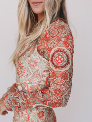 Person wearing a patterned dress with a white background