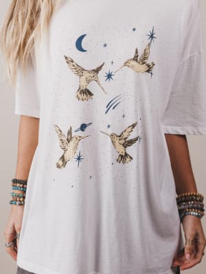 White t-shirt with bird and star design worn by a person