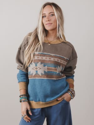 Woman wearing a patterned sweater with a neutral background