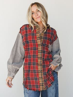 A mixed-fabric button-down shirt with a red and tan plaid flannel body and contrasting washed gray corduroy sleeves, styled with wide-leg denim for an effortlessly lived-in fall look.