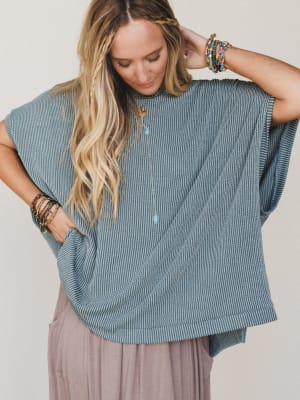 Woman wearing a blue shirt with a plain background