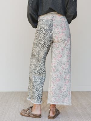 Person wearing patterned pants with a neutral background