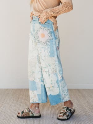 Person wearing floral-patterned pants with a neutral background