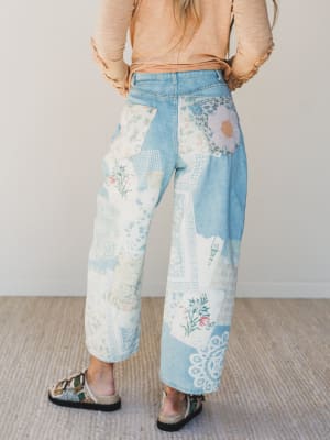 Person wearing floral-patterned pants with a neutral background