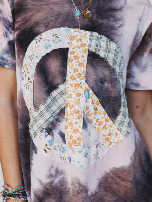 Floral peace sign design on a tie-dye dress