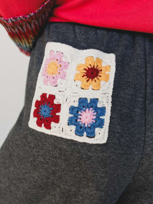 Floral patterned patch on a dark gray fabric background