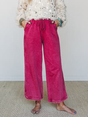 Acid-washed wide-leg pants in a bold raspberry-burgundy paired with a fluffy sequin crop top — the kind of outfit that looks effortless but makes a whole statement.