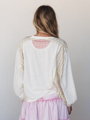 Shot from behind, this cream mixed-media top shows off its best detail — floral patchwork panels along the sleeves and back yoke, paired with a lavender tiered skirt for an effortlessly soft, boho-everyday look.