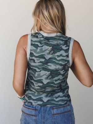 A back-view shot of a fitted camo tank top with heather gray trim, styled with medium-wash denim and stacked bracelets — the kind of easy, no-fuss top that looks like you tried just enough.