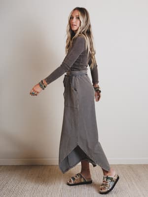 Person wearing a long, striped pants with a neutral background