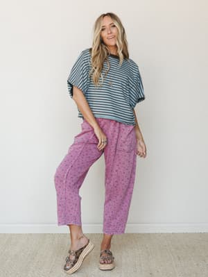 A relaxed, mix-and-match moment — oversized striped tee in dusty blue and brown paired with washed floral cargo pants in berry pink, finished with platform espadrille sandals and layered jewelry for that effortlessly collected everyday look.
