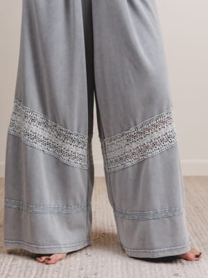 Gray pants with decorative hem on a neutral background