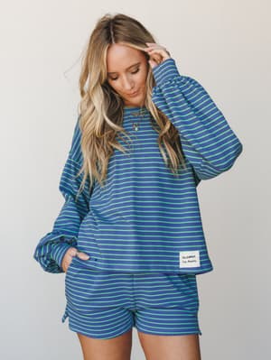 A matching striped set in bold navy and neon green — the kind of coordinated look that feels effortless but definitely got dressed on purpose, styled with layered necklaces and a relaxed, lived-in vibe.