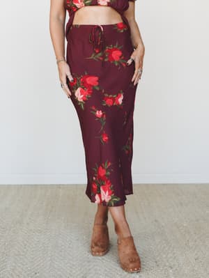 A rich wine floral midi skirt paired with a matching crop top and tan suede clogs — the kind of outfit that feels romantic without trying too hard.