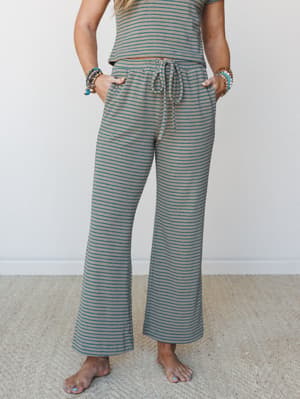A soft, striped wide-leg pant with a drawstring waist worn as a matching set — the kind of thing you put on for a slow morning and just never change out of.