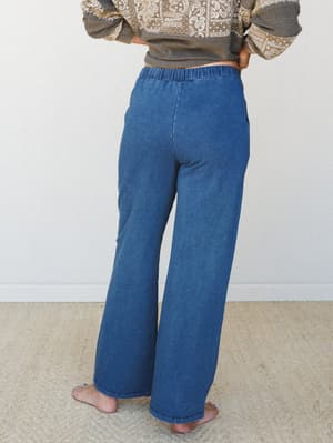 Back view of wide-leg denim-look pants with a soft elastic waistband, styled with a paisley print sweatshirt — the kind of outfit that makes you feel pulled-together without trying too hard.
