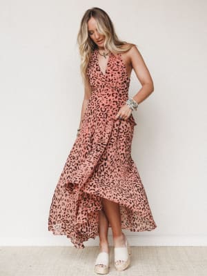 A flowy leopard-print maxi dress in dusty rose and brown styled with stacked turquoise bracelets and platform espadrilles — the kind of dress that moves when you walk and makes people ask where you got it.