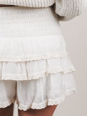 White ruffled skirt with a neutral background