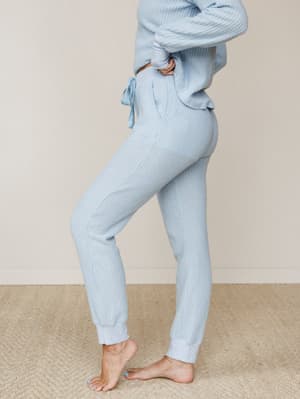 A soft, side-profile shot of a matching waffle-knit set in powdery sky blue — the kind of outfit that makes staying in feel like a whole personality.