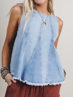 Denim sleeveless top worn by a person with a neutral background