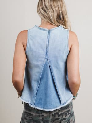 Back view of woman wearing a light blue denim sleeveless top